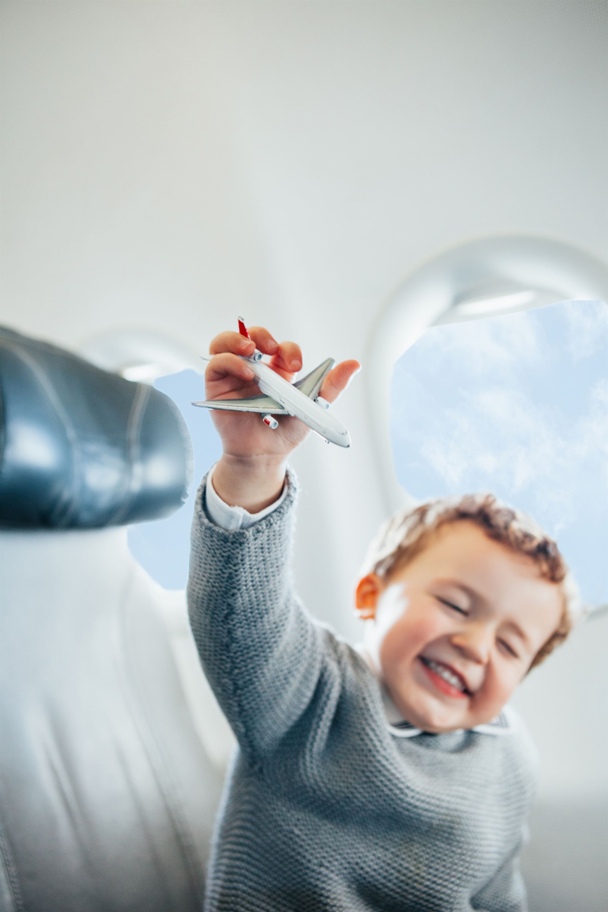 Boy-with-toy-airplane-on-flight